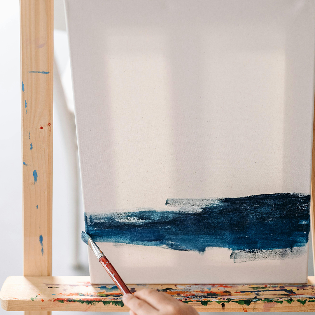 photo of a canvas with a smear of blue paint