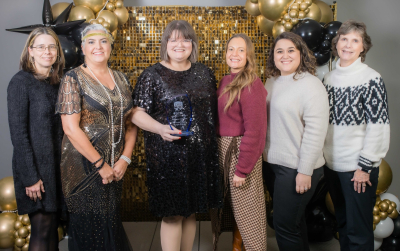 Photo of library employees and board members with the 2025 Business of the Year award