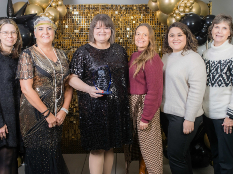 Photo of library employees and board members with the 2025 Business of the Year award
