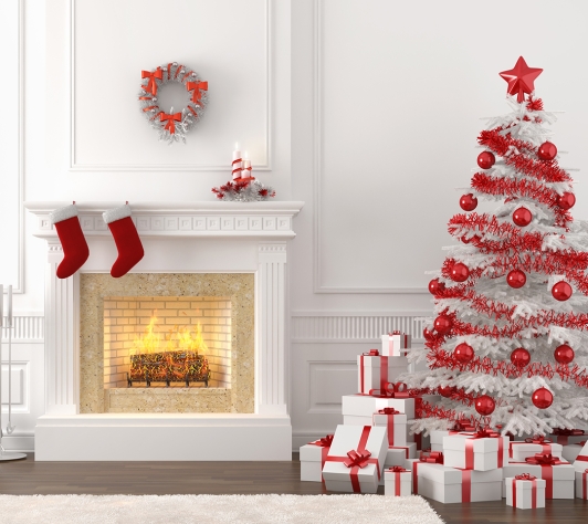 White fireplace with red stockings beside a white Christmas tree with red trimmings and presents