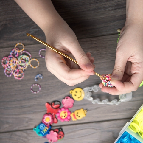 Table with beads, charms, and other craft supplies