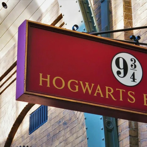 picture of a sign that says, "9 3/4" and "Hogwarts"