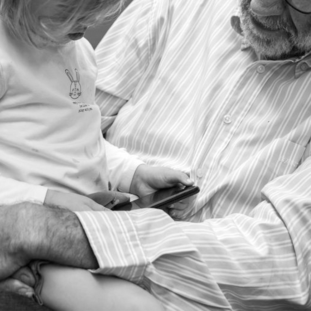 grandfather holding his granddaughter