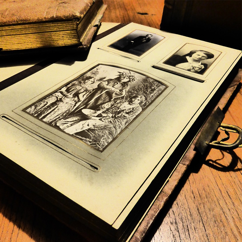 Photo of an old photo album with black and white pictures