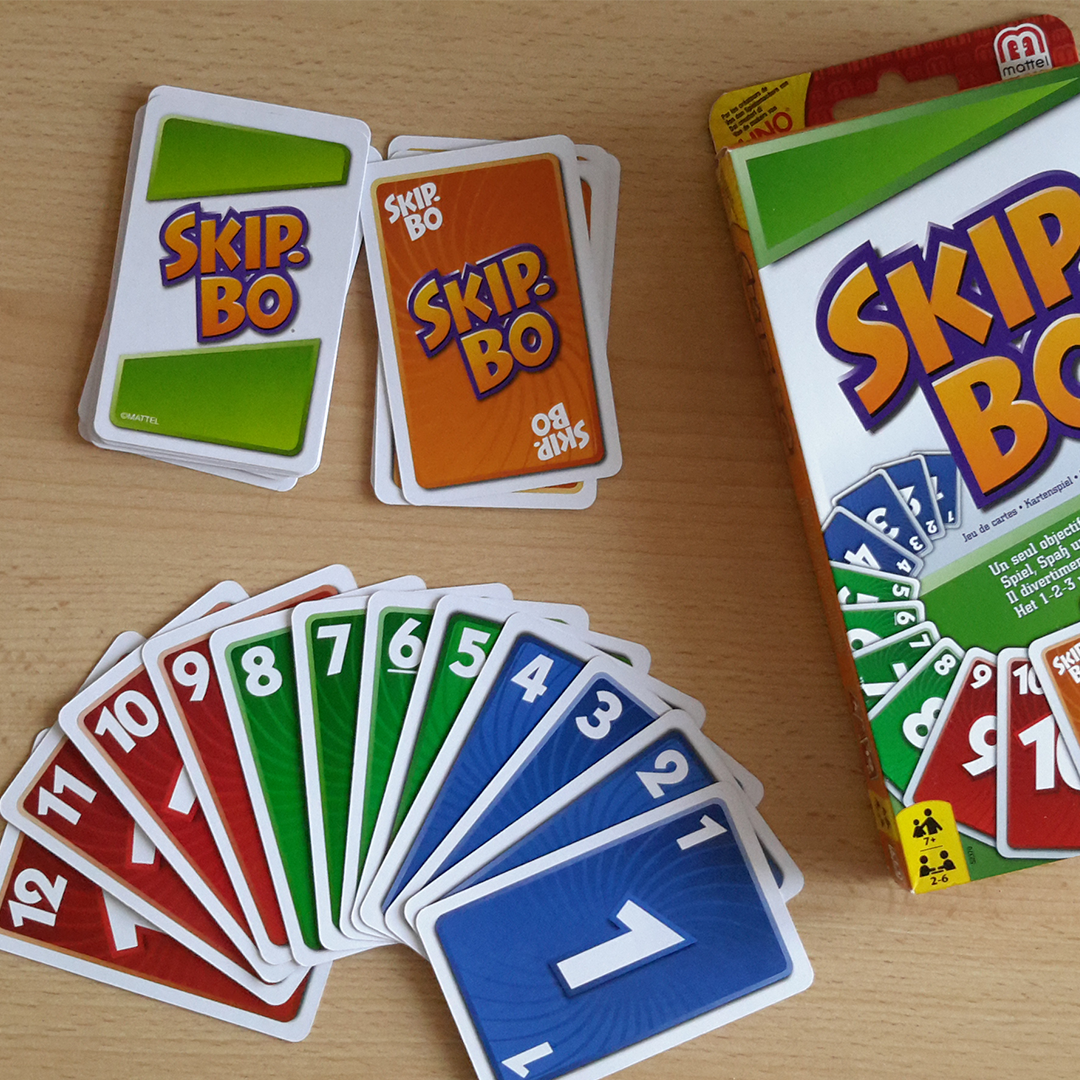 picture of a Skip-Bo box with the cards fanned out beside it